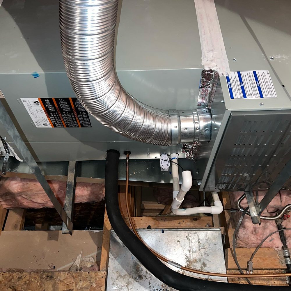 Attic air handler with duct connection, refrigerant lines, and condensate drainage